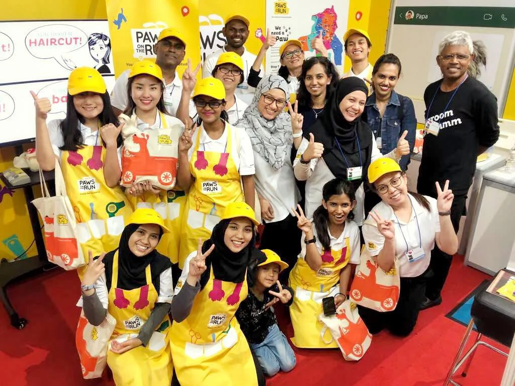 A group photograph of the Paws On The Run team of pet groomers at the expo
